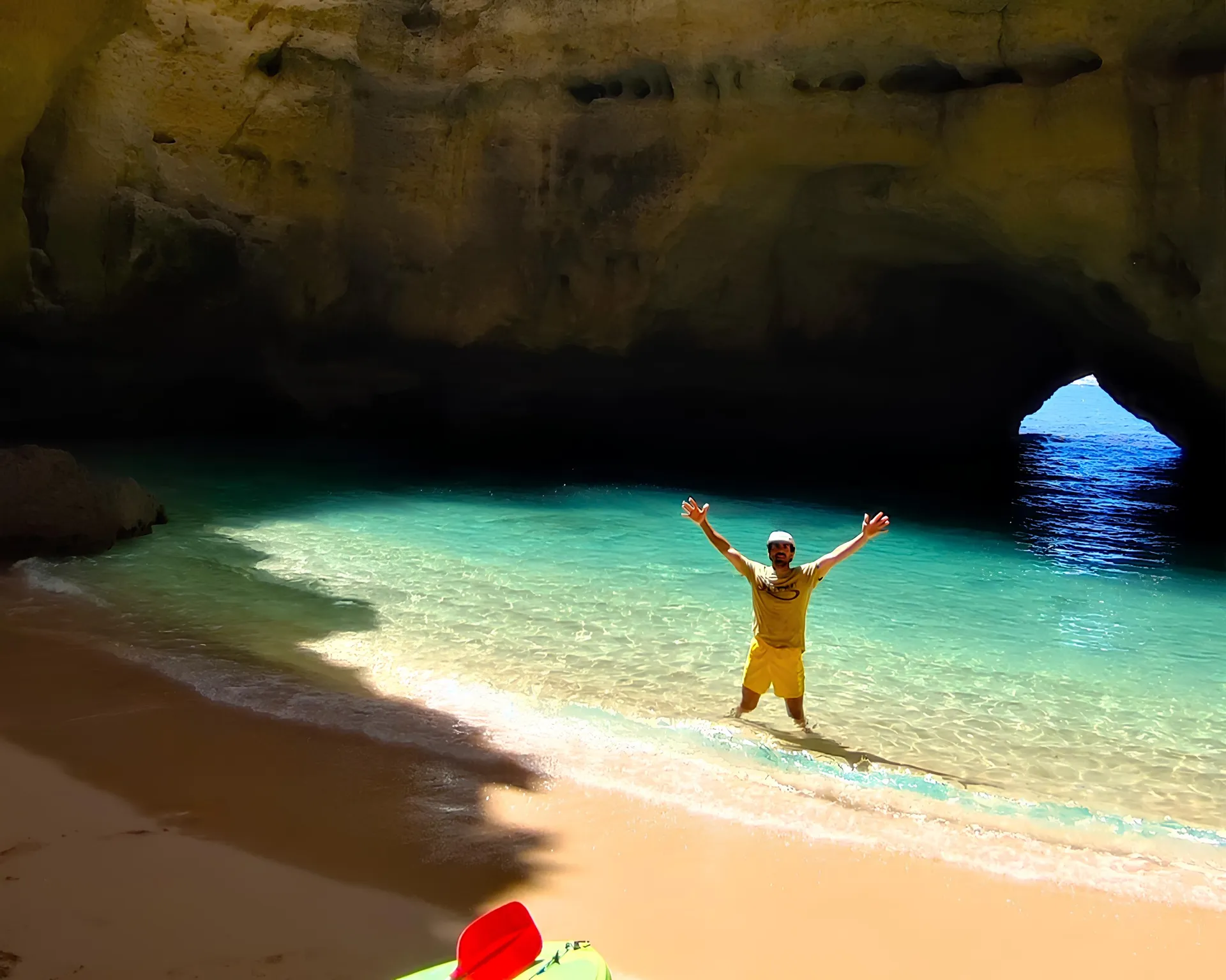 Guide David inside a hidden sea cave near Benagil, illuminated by light from the cave entrance – local expert guiding a kayak tour