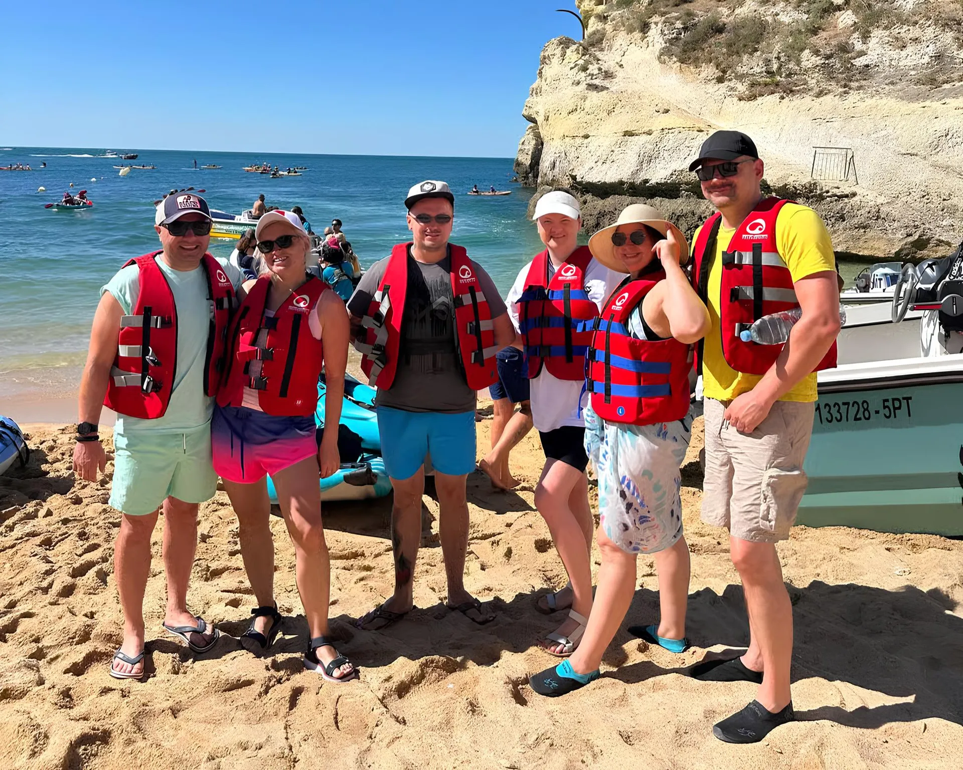 Salty Cliffs tour group ready to launch from Benagil Beach – guests in life jackets standing next to kayaks on the sand